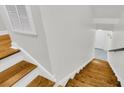 Staircase with hardwood steps and painted risers leads to the main living area with a bright and airy feel at 4030 Babbitt St, Charleston, SC 29414