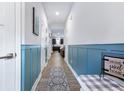 Long hallway with wood-look floors and wainscoting connecting living spaces at 412 Grand Palm Ln, Summerville, SC 29485