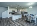 Modern kitchen with stainless steel appliances, granite countertops, and a large island for entertaining at 431 Buckhannon Ln, Moncks Corner, SC 29461