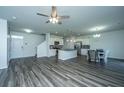 Spacious living room with modern flooring, a ceiling fan, and an open concept to the kitchen at 431 Buckhannon Ln, Moncks Corner, SC 29461