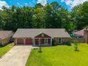 Beautiful home showcasing manicured lawn, mature trees, long driveway and desirable neighborhood at 439 Temple Rd, Ladson, SC 29456