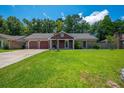 Inviting single-Gathering home with an attached garage and lush, green front yard on a sunny day at 439 Temple Rd, Ladson, SC 29456