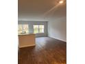 Open-concept space featuring modern flooring, large windows, and a functional kitchen island at 4669 Palm View Cir, North Charleston, SC 29418