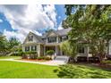 Inviting two-story home showcasing a well-manicured lawn and classic architectural details at 477 Commonwealth Rd, Mount Pleasant, SC 29466