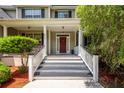 Inviting front porch with classic columns and a stylish entry door at 477 Commonwealth Rd, Mount Pleasant, SC 29466