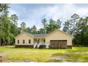 Yellow home showcasing the side-entry garage and covered front porch at 480 Longleaf Dr, Walterboro, SC 29488