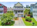 Inviting two-story home with a ground-level garage, landscaped front yard, and appealing curb appeal at 492 Sanders Farm Ln, Wando, SC 29492