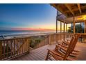 Relax on the deck with a beautiful ocean view in the distance at 505 E Arctic Ave, Folly Beach, SC 29439