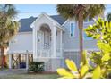 Charming beach home with elevated construction and lush lawn at 505 E Arctic Ave, Folly Beach, SC 29439