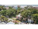 Aerial view of a two-story pink house near the beach and lush greenery at 509 E Ashley Ave, Folly Beach, SC 29439