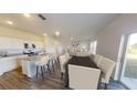 Open-concept kitchen with granite countertops, stainless steel appliances, and eat-in island at 550 Pender Woods Dr, Summerville, SC 29486