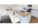 Granite kitchen island with a sink, gooseneck faucet, and bar stool seating at 550 Pender Woods Dr, Summerville, SC 29486