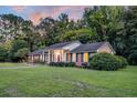 A well-maintained brick house features black shutters, a manicured lawn, and lush landscaping at 598 Maple Branch Rd, Reevesville, SC 29471