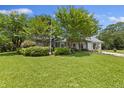 Charming single-story home with a well-manicured lawn and mature trees offering shade and curb appeal at 604 Longstreet St, Summerville, SC 29486