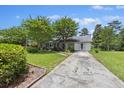 Charming single-story home with a well-manicured lawn, mature trees and long driveway at 604 Longstreet St, Summerville, SC 29486
