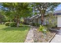 Landscaped front yard with a stone walkway leading to a cozy single-story home at 604 Longstreet St, Summerville, SC 29486