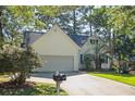 Traditional-style home featuring a driveway, lawn, mailbox, and mature trees at 642 Bridlewood Ln, Mount Pleasant, SC 29464