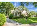 Charming home with brick facade and well-manicured lawn is complemented by mature trees and inviting curb appeal at 652 Spinner Cir, Mount Pleasant, SC 29464