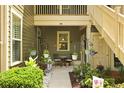 Cozy outdoor patio with table, chairs, and hanging plants for relaxing and entertaining guests at 8400 Camp Gregg Ln, North Charleston, SC 29418