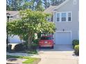 Two-story home with a well-maintained lawn and a driveway with a parked car at 9430 Sweep Dr, Summerville, SC 29485