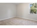 Neutral carpeted bedroom with a double-hung window showing natural light at 100 Claret Cup Way, Charleston, SC 29414