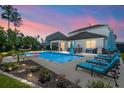 Inviting backyard oasis featuring a sparkling pool, comfortable lounge chairs, and an outdoor seating area at 106 Claremont Ct, Summerville, SC 29486