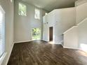 Spacious living room with high ceilings, modern flooring, and plenty of natural light from large windows at 109 Rosefield Ct, Summerville, SC 29485