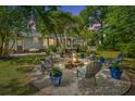 Backyard patio space featuring an outdoor fire pit with Adirondack chairs creating a space for entertaining and relaxing at 1098 Blue Marlin Dr, Charleston, SC 29412