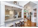 Open-concept kitchen featuring granite countertops, a breakfast bar with stools, and views to the front entryway at 1098 Blue Marlin Dr, Charleston, SC 29412