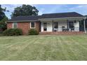 The front yard of a well-maintained single-story home, showcasing its classic brick and siding exterior at 1139 Belvedere Dr, Hanahan, SC 29410