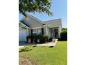 Charming single story home with patriotic decorations, grey siding, and well maintained landscaping at 120 Townsend Way, Summerville, SC 29483