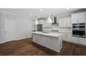 Modern kitchen features a large center island, stainless steel appliances and sleek white cabinetry at 124 Cantona Dr, Summerville, SC 29483