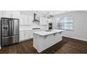 Modern kitchen features a large center island, stainless steel appliances and sleek white cabinetry at 124 Cantona Dr, Summerville, SC 29483