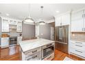Open concept kitchen featuring stainless steel appliances, pendant lighting, and a large kitchen island at 136 Fair Sailing Rd, Mount Pleasant, SC 29466
