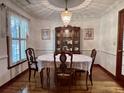 Formal dining room featuring a classic chandelier, wood floors, and traditional furnishings for elegant dining at 14 Ashland Dr, Charleston, SC 29407
