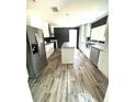 Modern kitchen with stainless steel appliances, white cabinets, and a center island at 144 Craft Ln, Round O, SC 29474