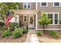 Inviting front entrance with a decorative wreath, 'Welcome' sign, and manicured landscaping leading to the front door at 165 Village Ponds Dr, Summerville, SC 29483