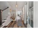 Entryway showcasing hardwood floors, a staircase, and a view through to the bright and open living spaces at 165 Village Ponds Dr, Summerville, SC 29483
