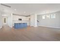 Open-concept kitchen features white cabinets, stainless appliances, an island, and an adjacent living space at 186 Queenview Ln, Charleston, SC 29414