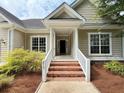 Welcoming entrance with brick steps, white railing, and a covered porch offering curb appeal at 213 Ashmont Dr, Wando, SC 29492