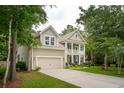 Charming two-story home with well-manicured lawn, two-car garage and covered porch at 233 Camber Rd, Huger, SC 29450