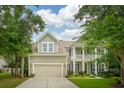 Charming two-story home with well-manicured lawn, two-car garage and covered porch at 233 Camber Rd, Huger, SC 29450