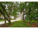 Charming two-story home with well-manicured lawn, two-car garage and a hammock at 233 Camber Rd, Huger, SC 29450