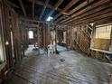 Stripped interior showing wood beams, exposed framing, studs, wood floors, and room layout at 2334 Kent Ave, North Charleston, SC 29405