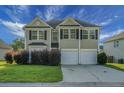 Charming two-story home with a well-maintained lawn, a two-car garage, and neatly trimmed bushes in the front yard at 3013 Argyll Dr, Summerville, SC 29483