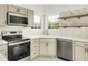 Modern kitchen features stainless steel appliances, white marble-style backsplash, and cabinetry with brass hardware at 3013 Argyll Dr, Summerville, SC 29483