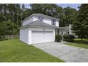 Charming two-story home with a two-car garage, well-kept lawn, and a driveway, surrounded by lush greenery at 340 Stefan Dr, Charleston, SC 29412