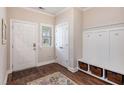Inviting entryway with wood floors, coat rack and storage, and white trim at 4117 Rigsby Ln, Charleston, SC 29414