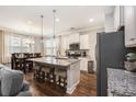 Eat-in kitchen with granite countertops, stainless steel appliances, and an island with stool seating at 4117 Rigsby Ln, Charleston, SC 29414