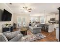 Open-concept living room and kitchen featuring hardwood floors and stainless steel appliances at 4117 Rigsby Ln, Charleston, SC 29414
